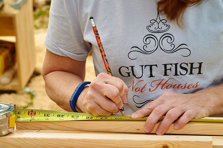 A student at one of Wood Window Makeover's sash making classes, uses a common measuring tape